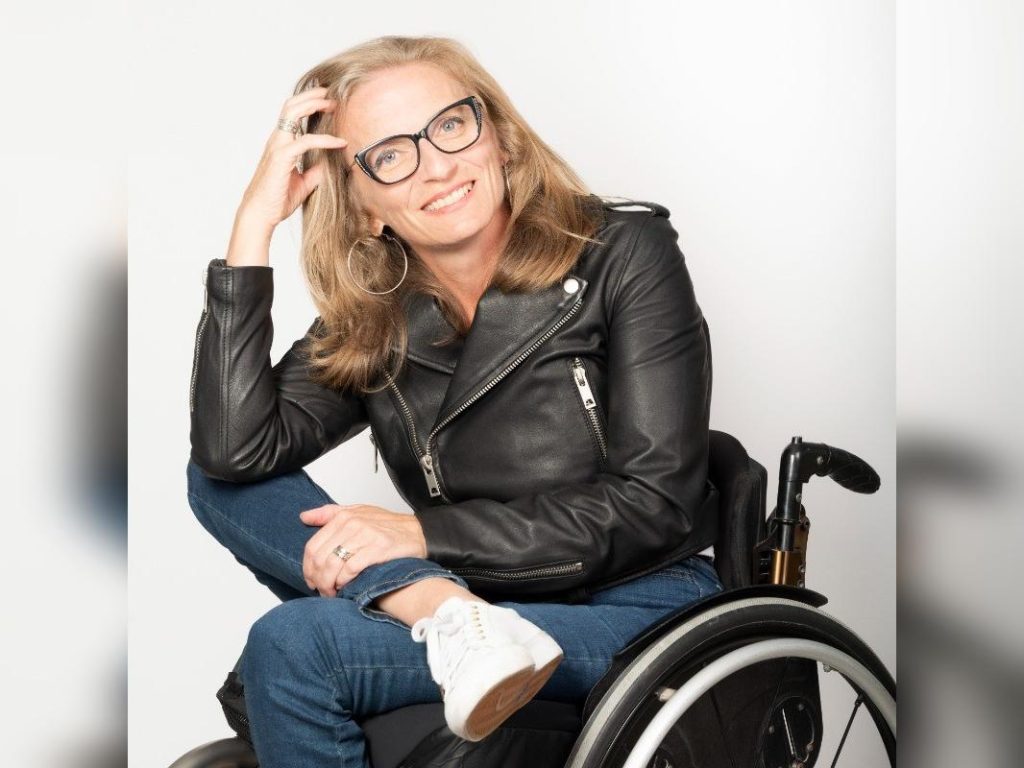 Julie Sawchuk sits in a manual wheelchair with her legs crossed.