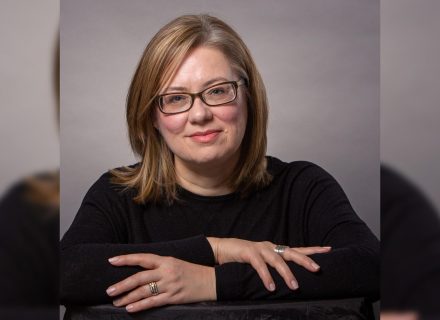 Photo of Jennifer. A woman wearing black glasses with thick lenses.