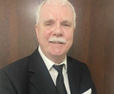 Headshot of Tim Nolan, a man with short white hair and bushy white moustache.